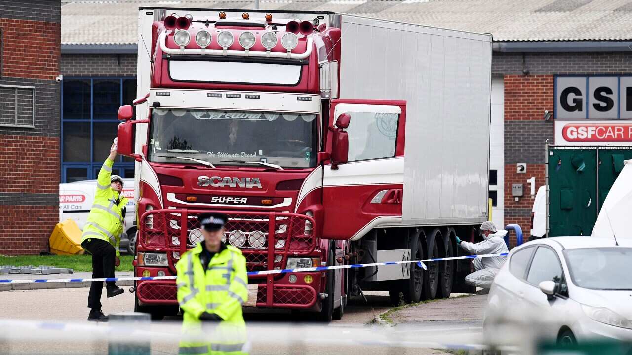 Police and forensic officers investigate the truck, in which 39 bodies were discovered last year.