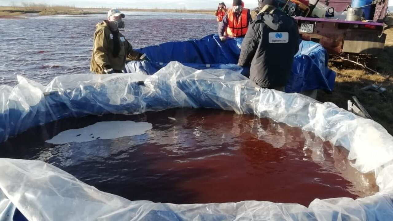 Rescuers working at the site of oil products spill into the Ambarnaya river outside of Norilsk, Russia.
