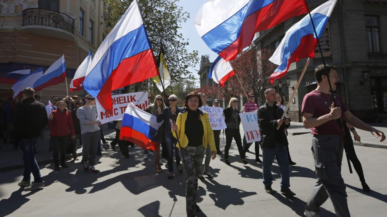 Demonstrators carry Russian flags in Crimea