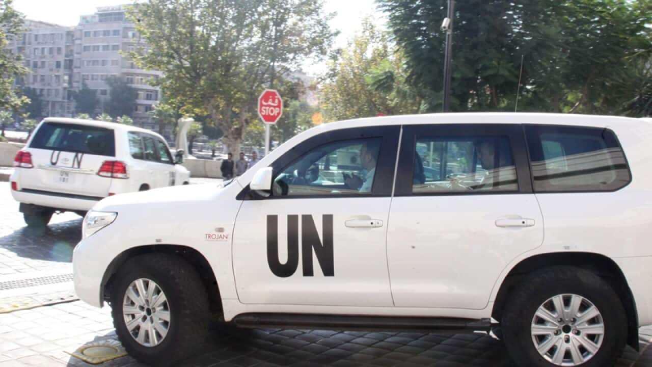 A convoy of cars of the team of weapons experts leaves their hotel