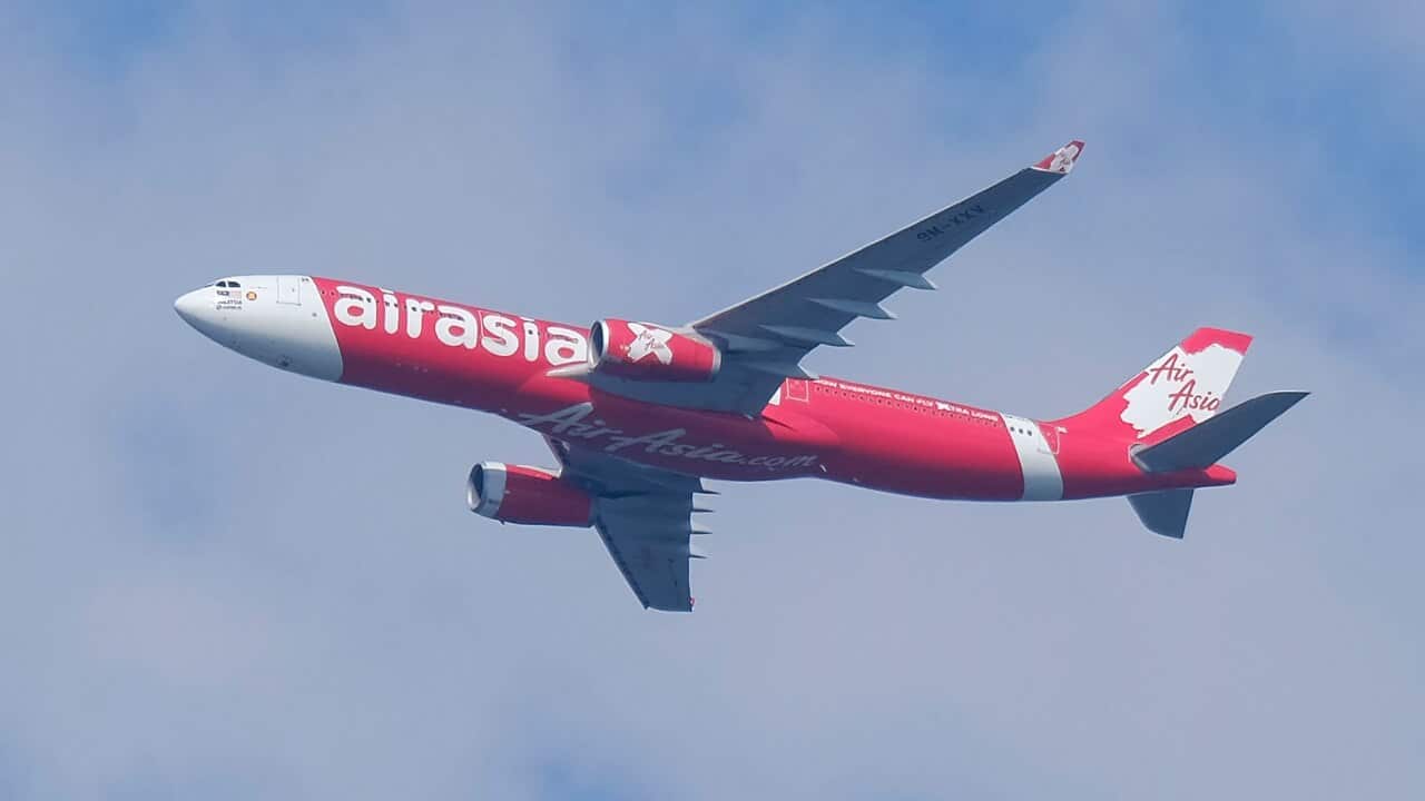 An AirAsia airplane seen flying in the sky at Kuala Lumpur