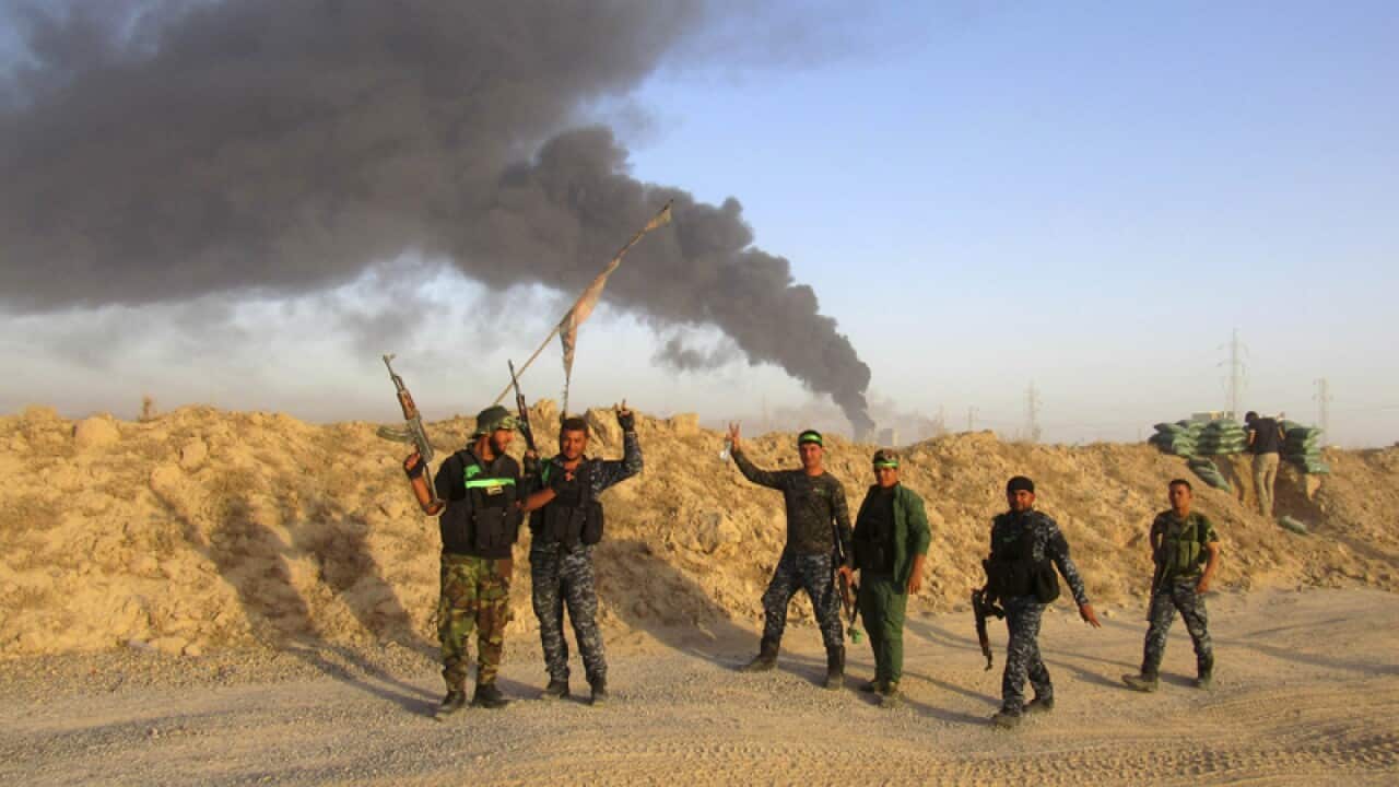 Smoke rises from Islamic State group positions