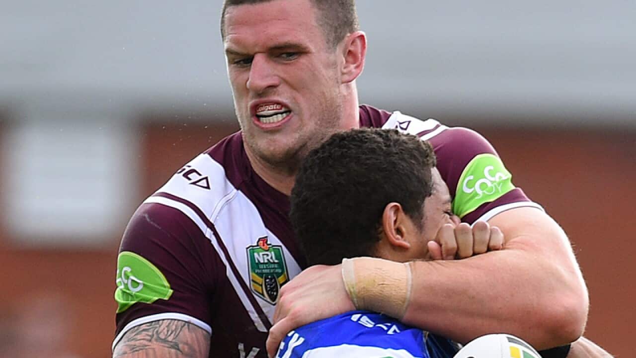 Dane Gagai of the Knights is tackled by Luke Burgess of the Sea Eagles