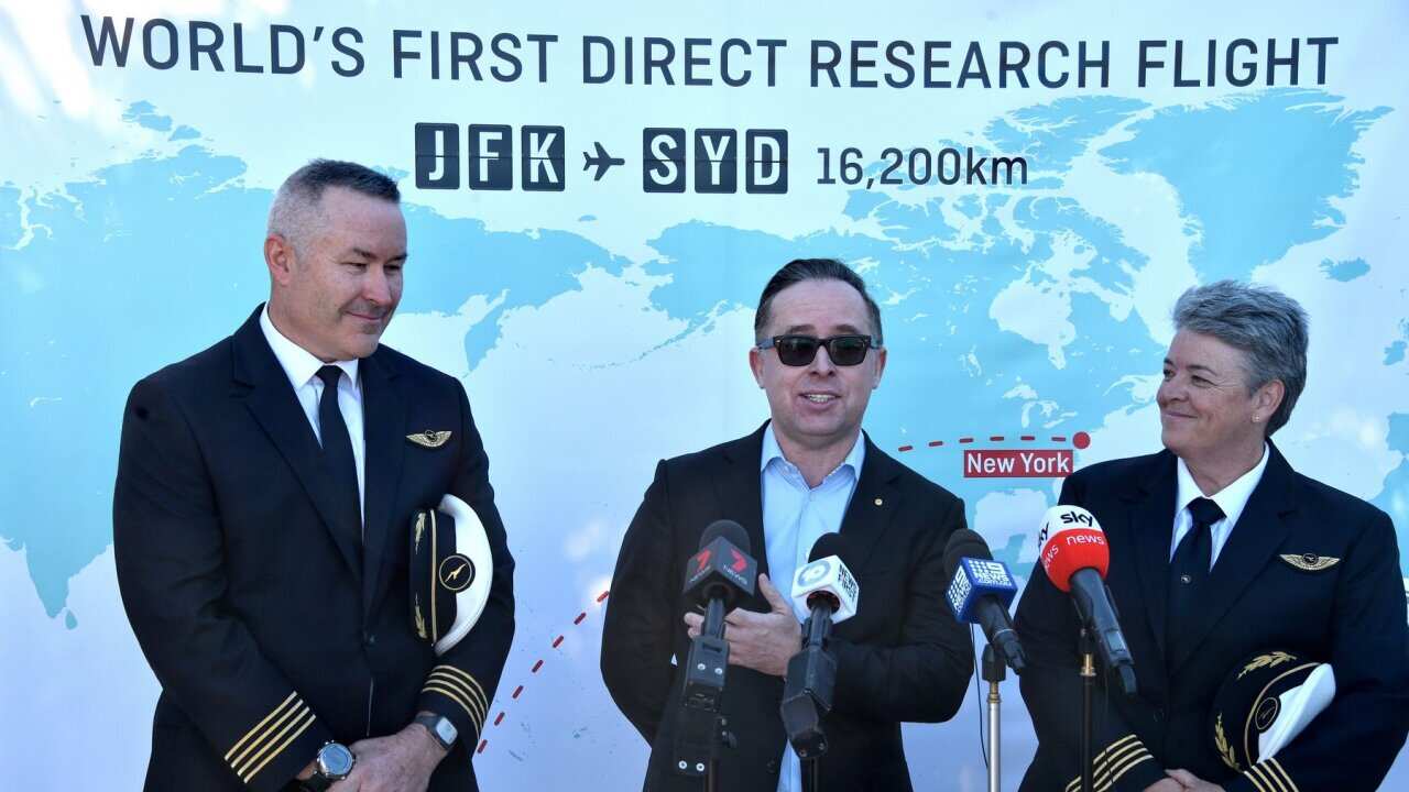 Qantas Group CEO, Alan Joyce (C) speak to the media after completing a non-stop test flight from New York to Sydney at Sydney airport on October 20, 2019.