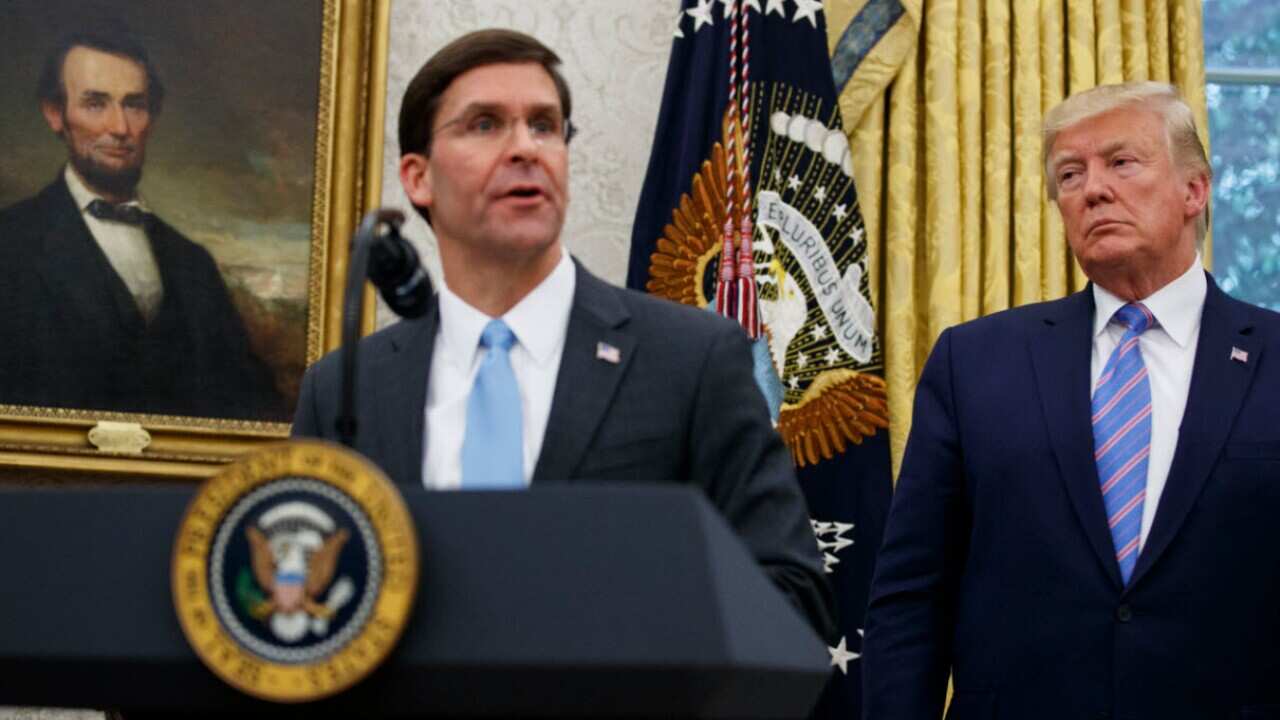 President Donald Trump looks to Secretary of Defense Mark Esper during a ceremony in the Oval Office at the White House in Washington, July, 2019.