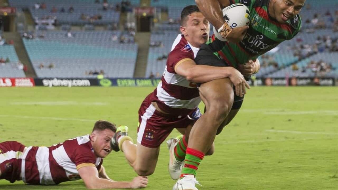Rabbitohs Richard Kennar beats a tackle to score at a game in Sydney.