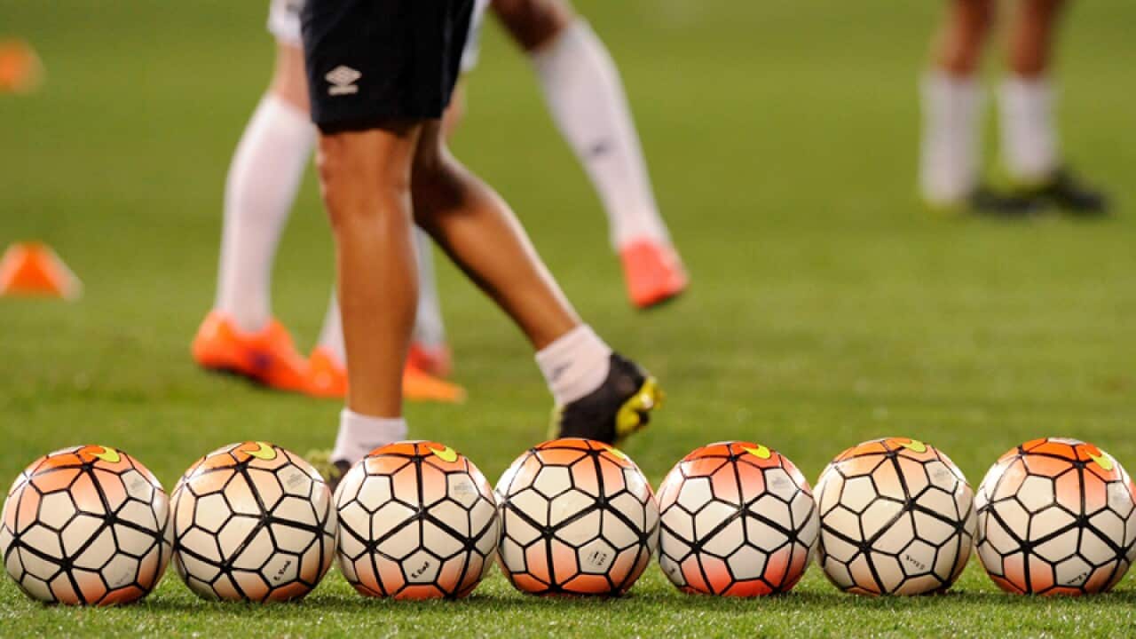 Soccer balls on a pitch