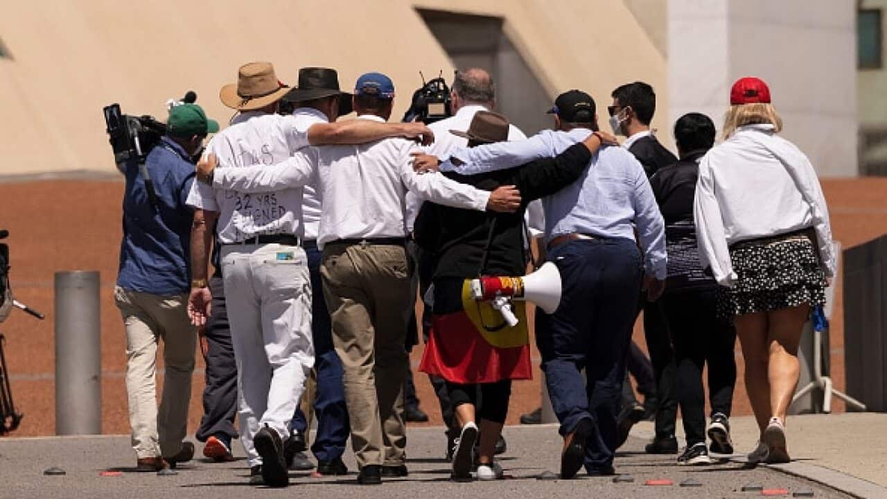 Independent MP Craig Kelly (centre) escorting members of the anti-vaccination mandate movement into Parliament House in Canberra on 8 February, 2022.