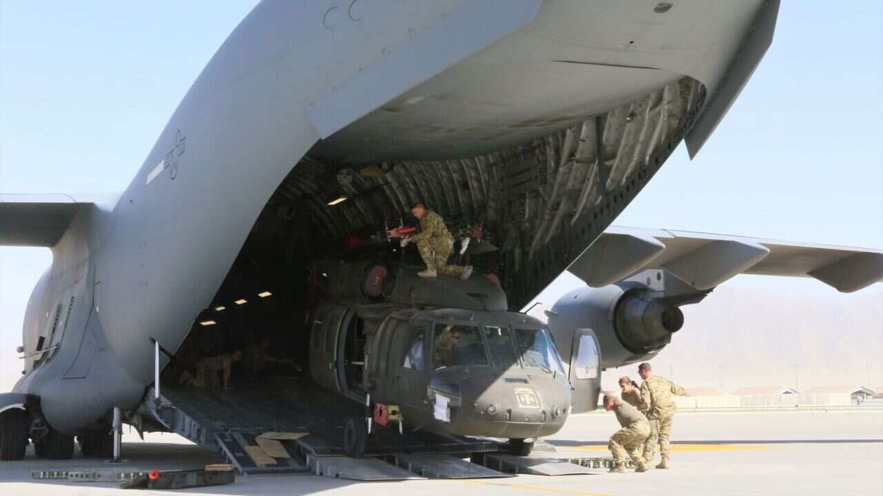 Loading a Blackhawk helicopter into a C-17 Globemaster III in support of the Resolute Support retrograde mission in Afghanistan,