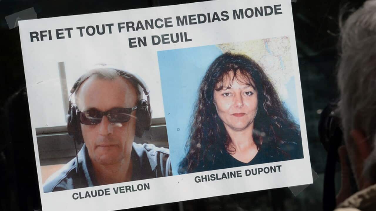 A poster showing the two French journalists killed in Mali