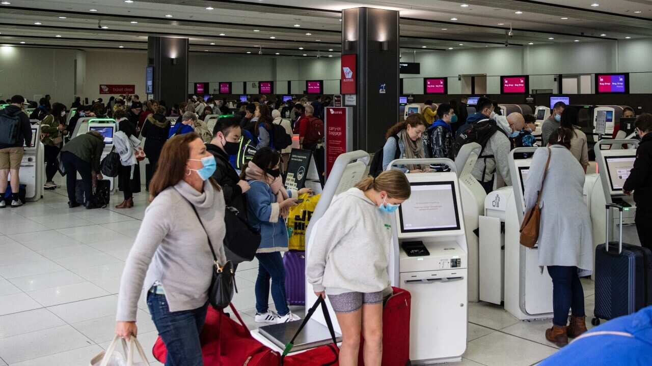 People are seen waiting and lining up at Melbourne International Airport