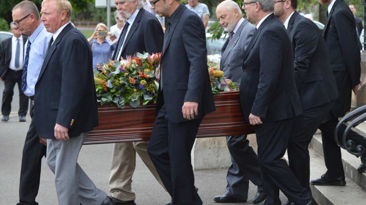 The coffin of John Bannon is carried from a memorial