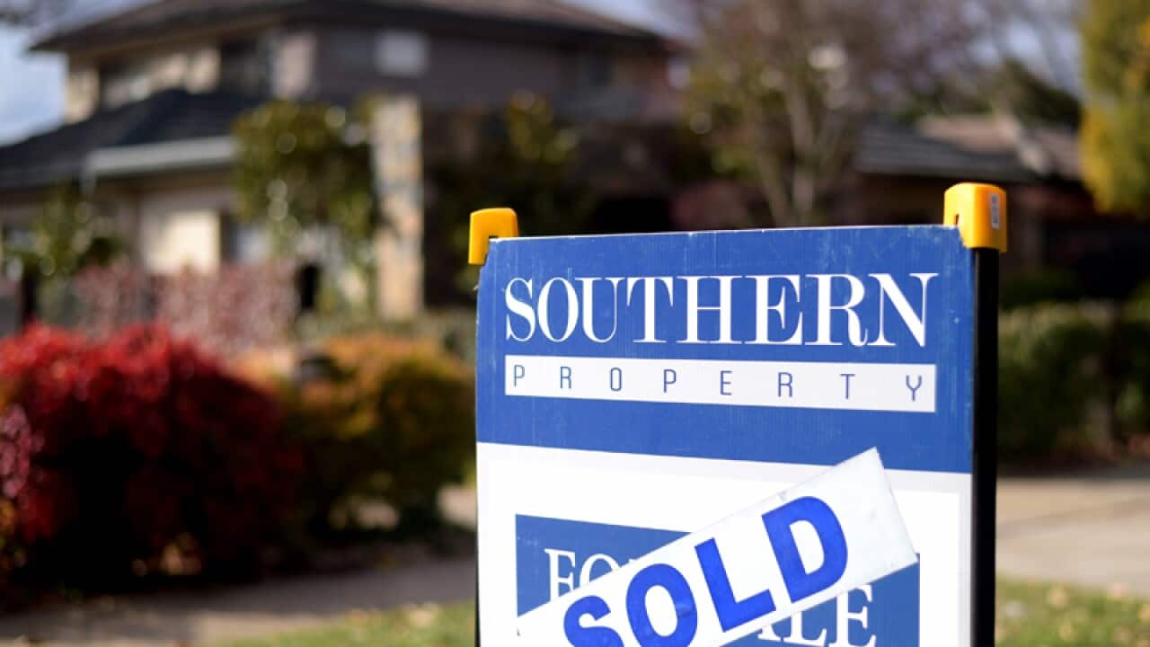 A sold sign in front of a house