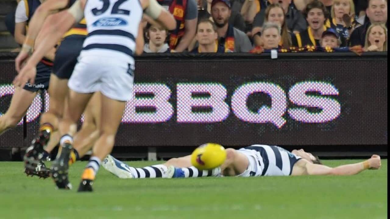 Patrick Dangerfield of the Cats lies on the ground