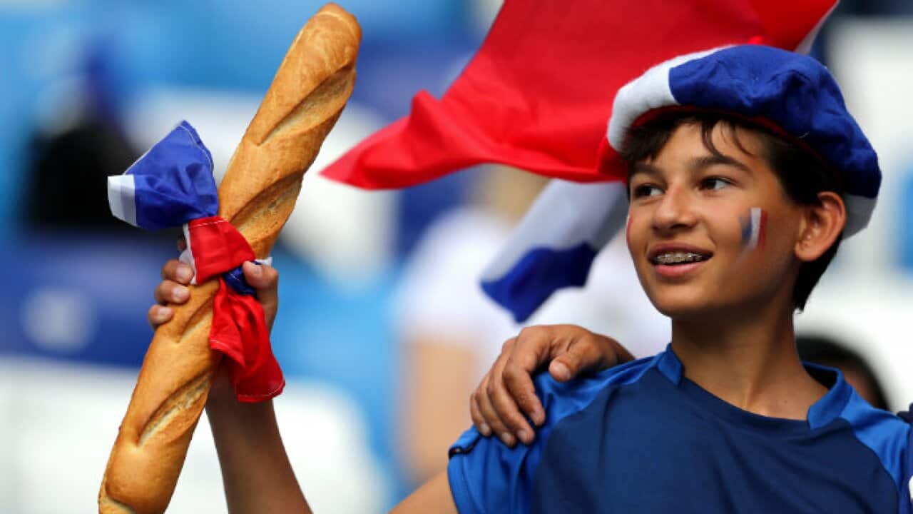 French boy with a baguette at the 2018 FIFA World Cup