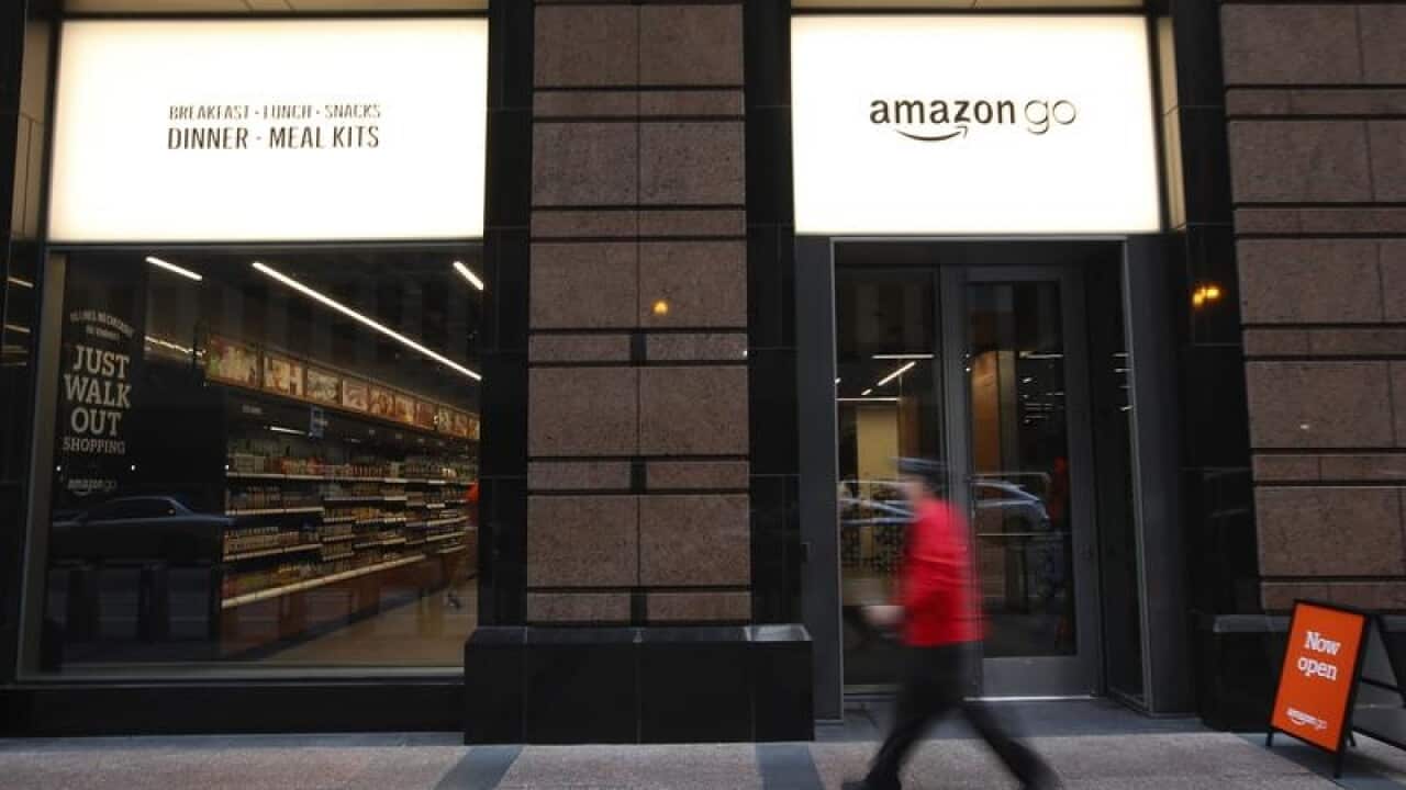 Pedestrians in front of a new Amazon Go store in Chicago
