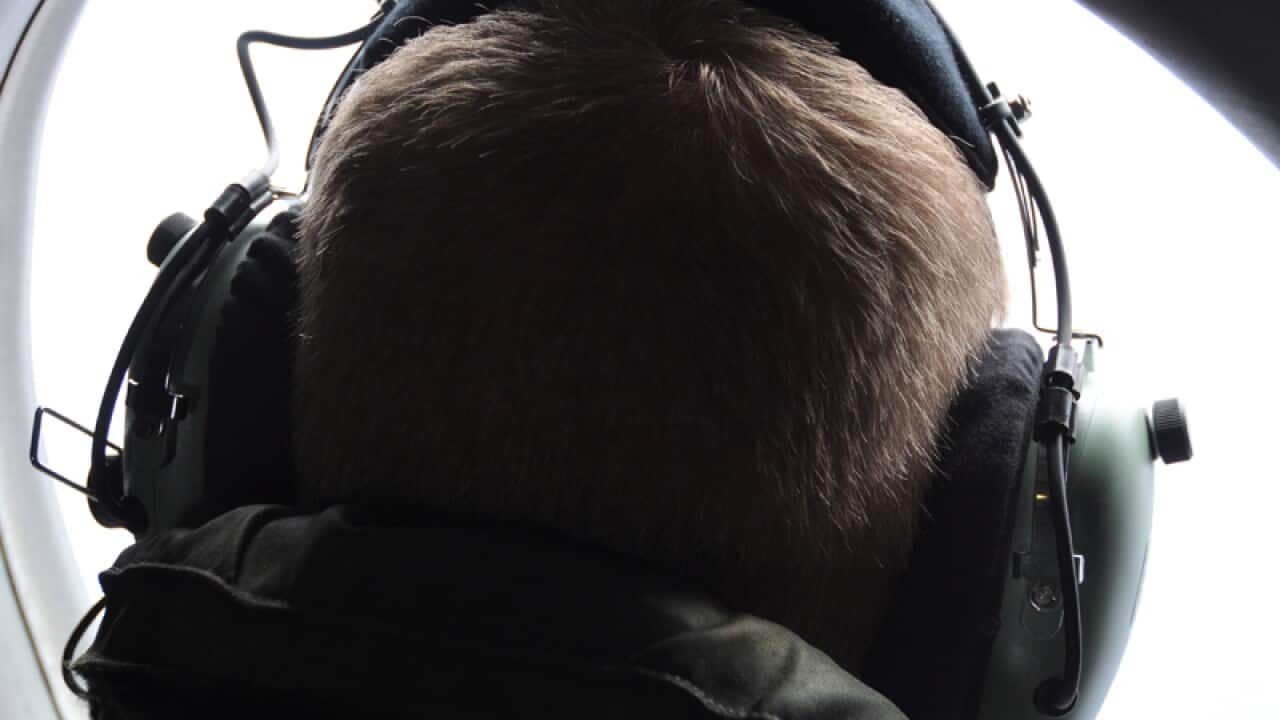 Royal New Zealand Air Force officer searches for the missing plane.