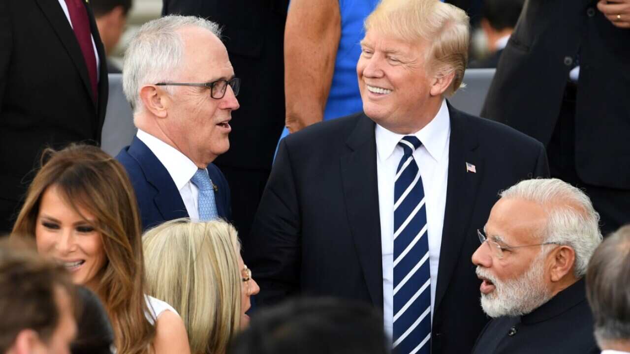 Australian Prime Minister Malcolm Turnbull (left) speaks with US President Donald Trump after a family photo at 'Elbphilharmonie' during the G20 summit 