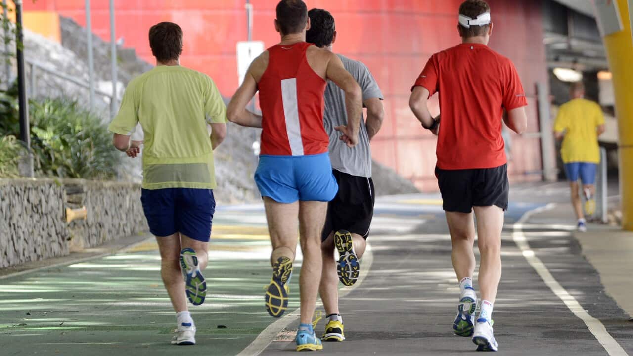 People run during lunch time in Brisbane, Thursday, July 4, 2013. (AAP Image/Dan Peled) NO ARCHIVING