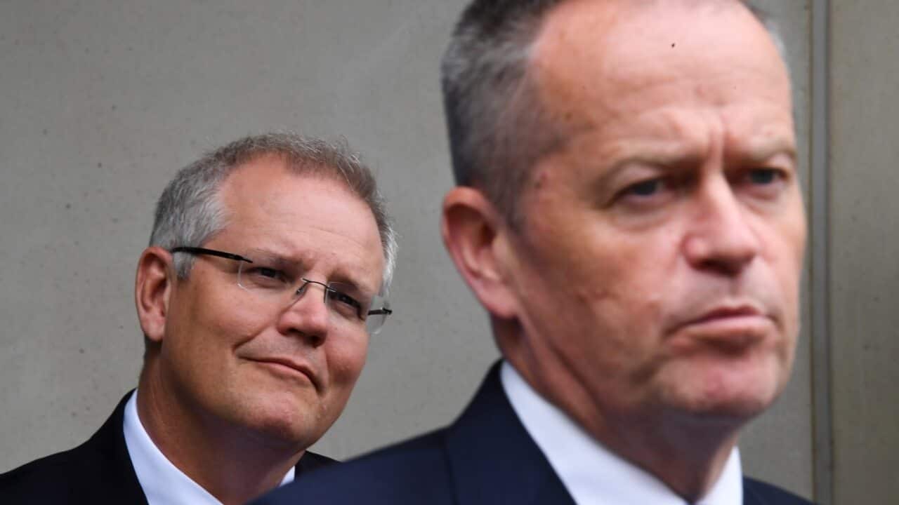 Australian Prime Minister Scott Morrison (back) listens to Australian Opposition leader Bill Shorten during a Prostate Cancer Foundation barbecue event