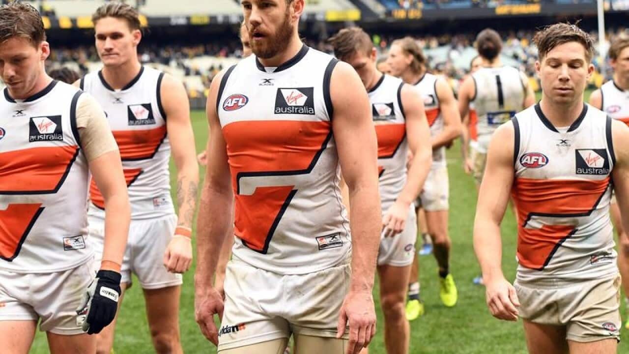 Giants players leave the MCG.