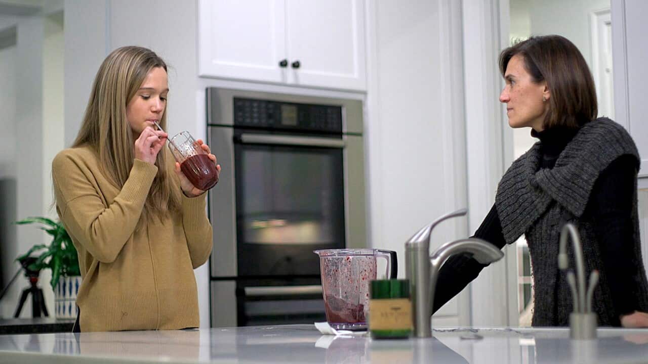 Nina Nichols takes her daily dose of Palforzia as her mother, Maria Acebal watches