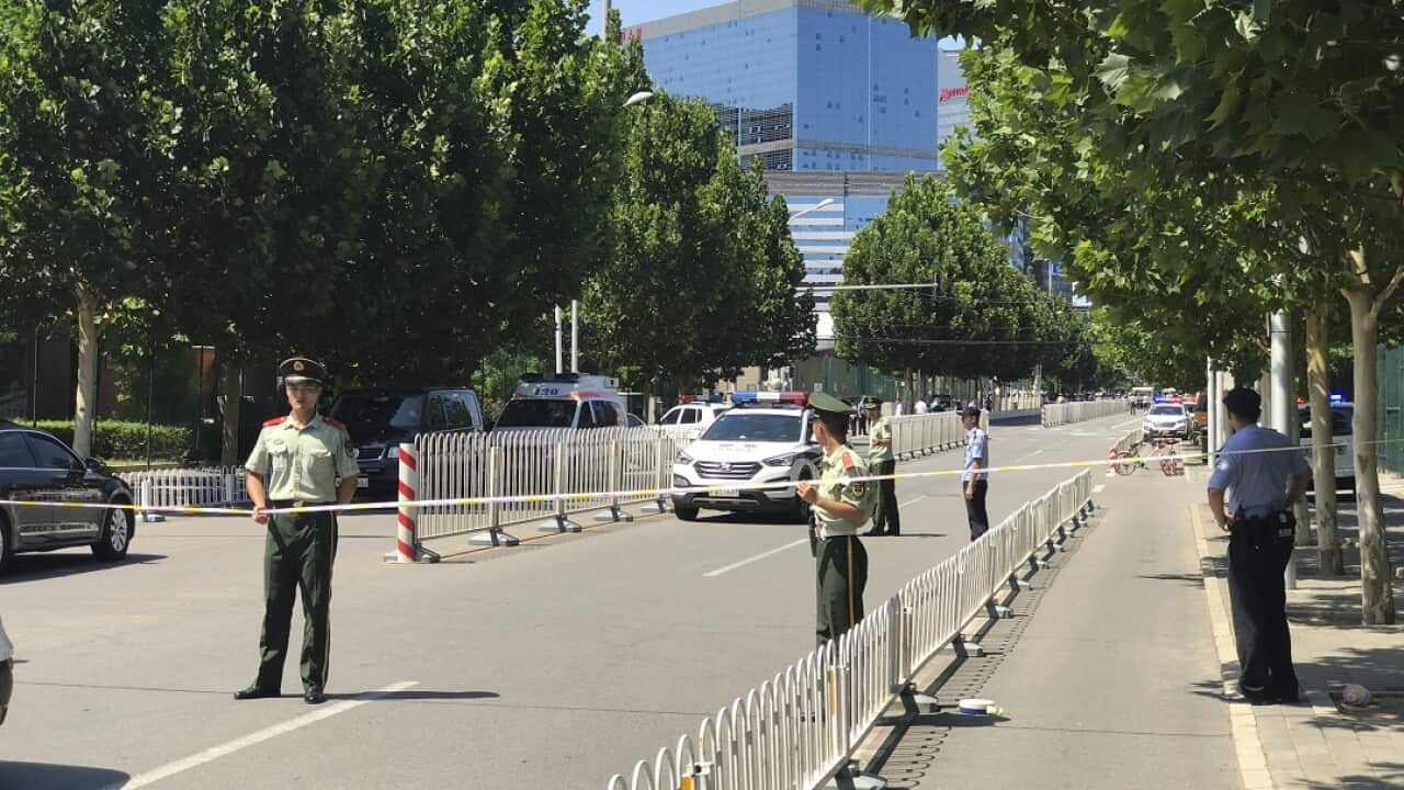 Paramilitary policemen seal off the road leading to the US Embassy in Beijing on Thursday.