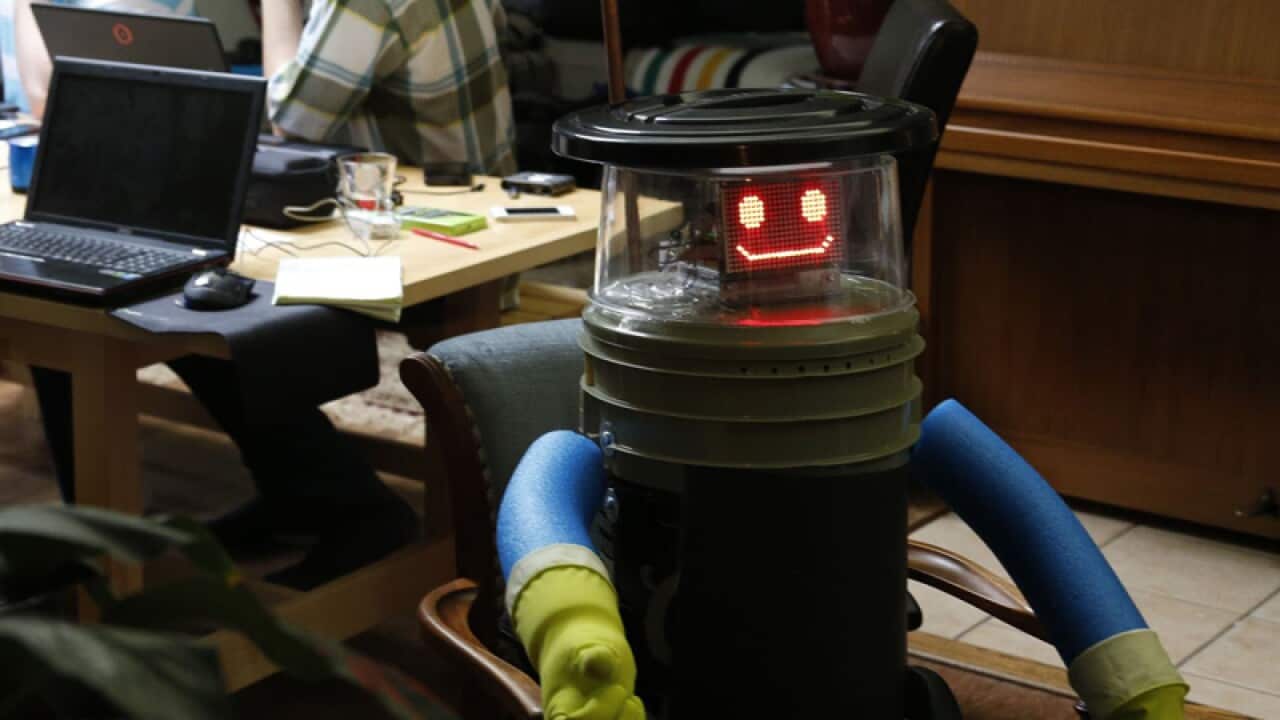 HitchBOT at home with its research team in Port Credit.