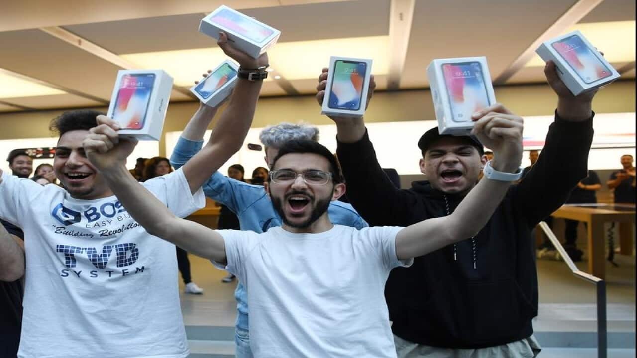 Mazen Kourouche (centre), one of the first purchasers of the iPhone X
