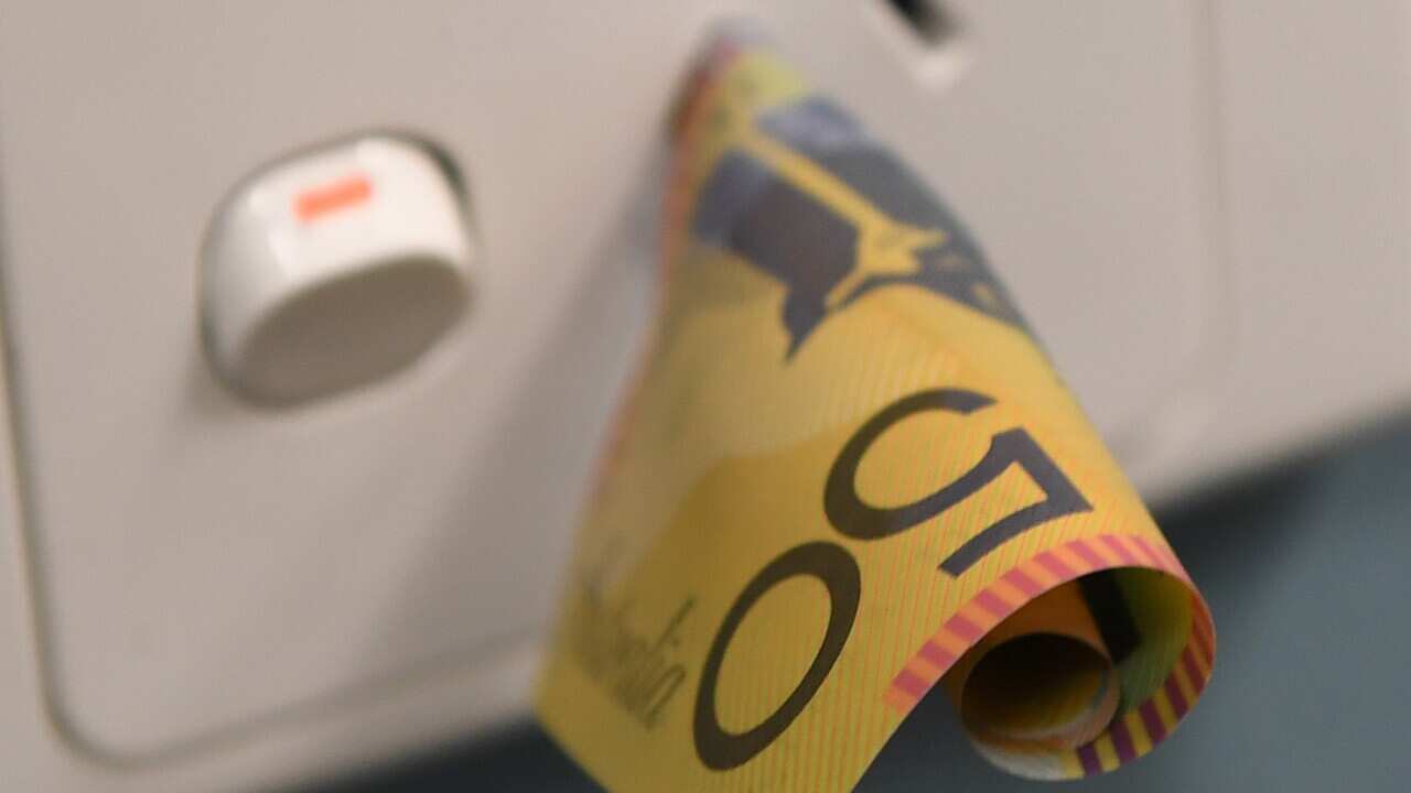 A $50 note is seen inserted into a power point (AAP).