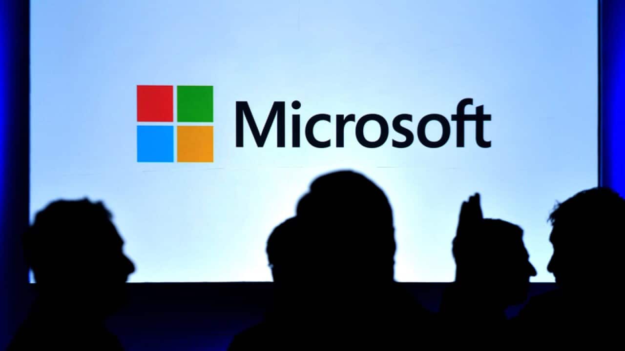 Indian visitors standing in front of Windows 8 screen