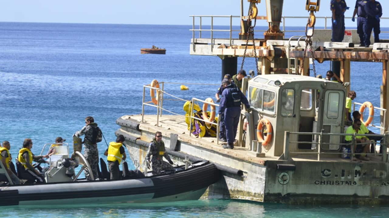 Passengers receive medical care after an asylum seeker boat capsized