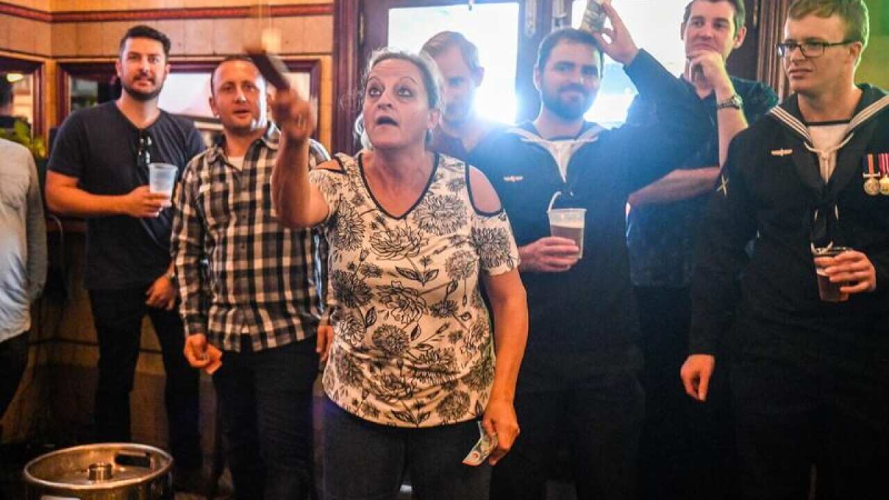 Pubgoers play two-up in the Edinburgh Hotel.