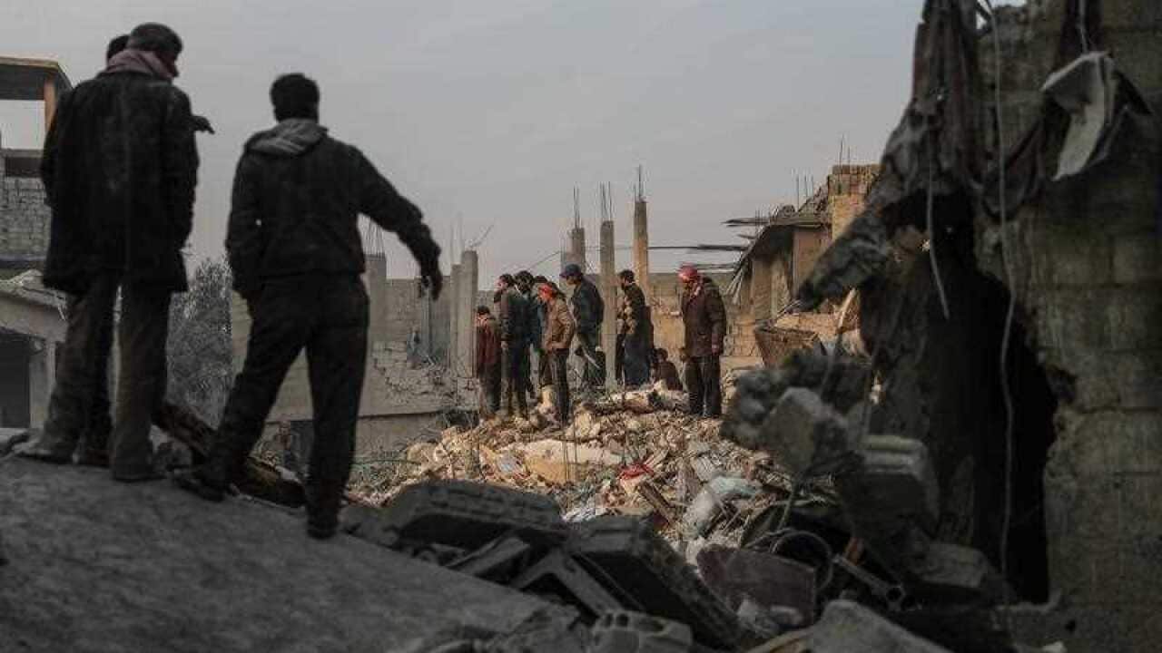 Civilians and White Helmets volunteers search for survivors after several air strikes destroyed civil buildings in Hamoria city, al-Ghouta, Syria, 09 January 2