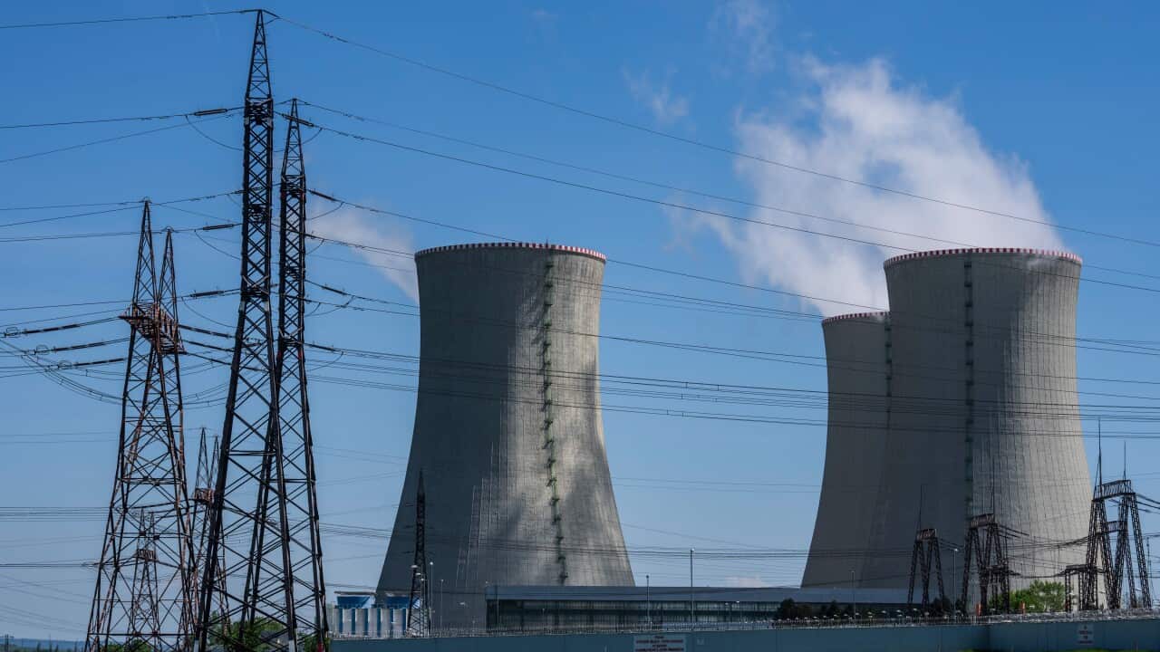 Steam rising from cooling towers at a nuclear power plant.