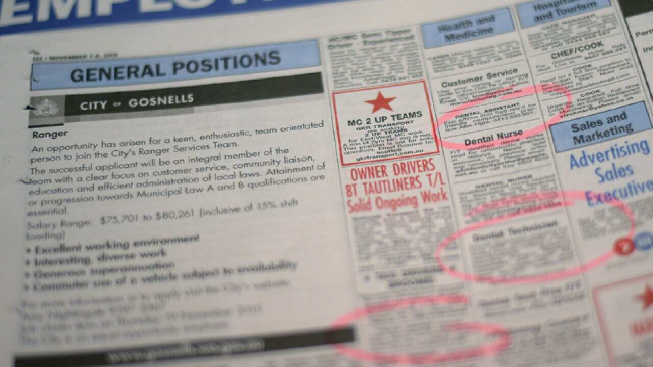 Job adverts are seen in a weekend newpaper in Canberra, Wednesday, Nov. 11, 2015. (AAP Image/Lukas Coch) NO ARCHIVING