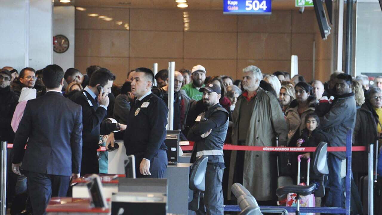 Passengers of a Turkish Airlines flight wait at the boarding gate