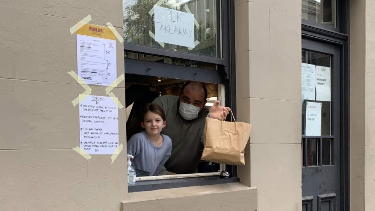 Jovan and his daughter at the Pub Life Kitchen take away window.