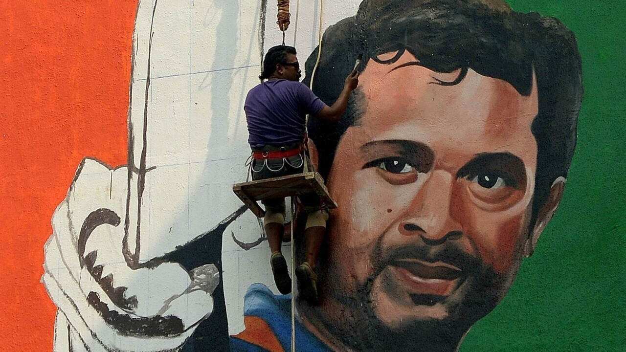 Artist Ranjit Dahiya works on a mural of cricketer Sachin Tendulkar on the wall of a sports club building in Mumbai - AAP.jpg