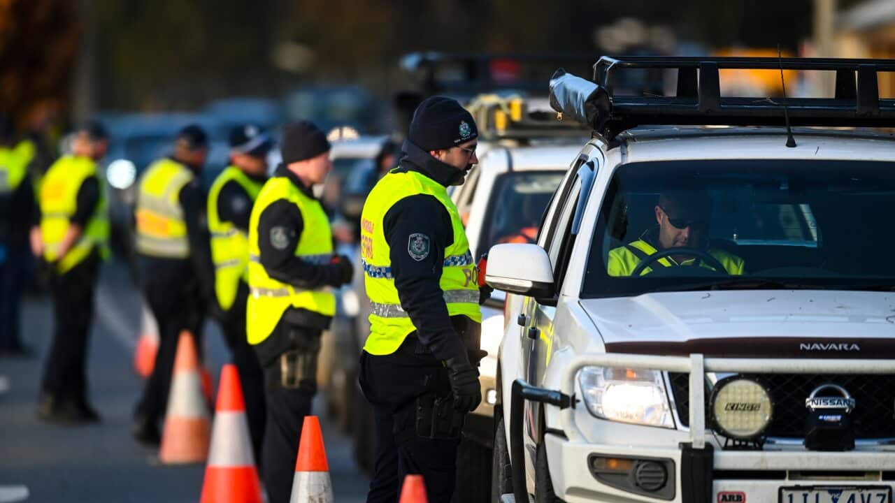 NSW Police officers check cars crossing from Victoria into New South Wales at a border check point in Albury, NSW, Wednesday, 8 July, 2020.
