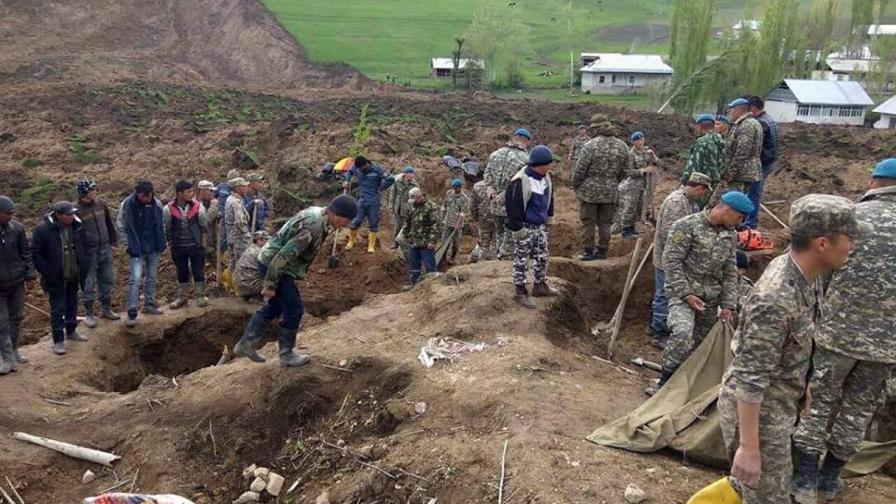 rescue workers searching at Aiyu village which was hit by a landslide in Osh, Kyrgyzstan