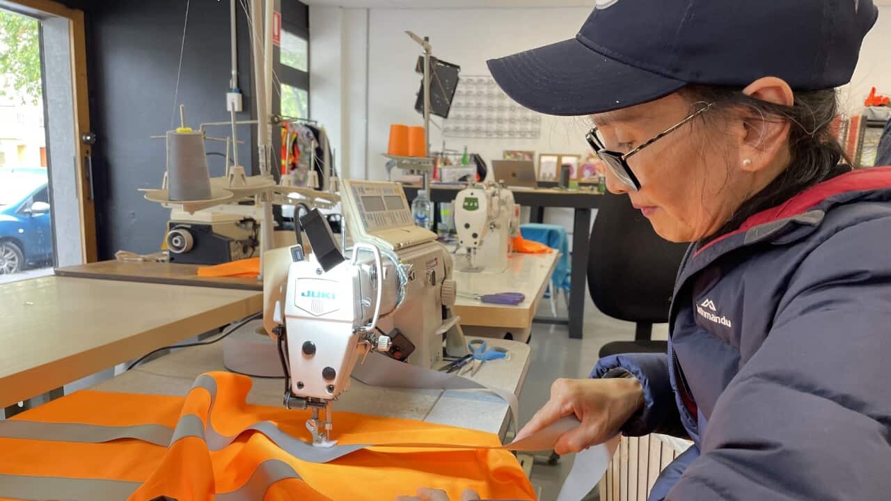 Thi Le working on the hi-viz vests (SBS-Tys Occhiuzzi).jpg