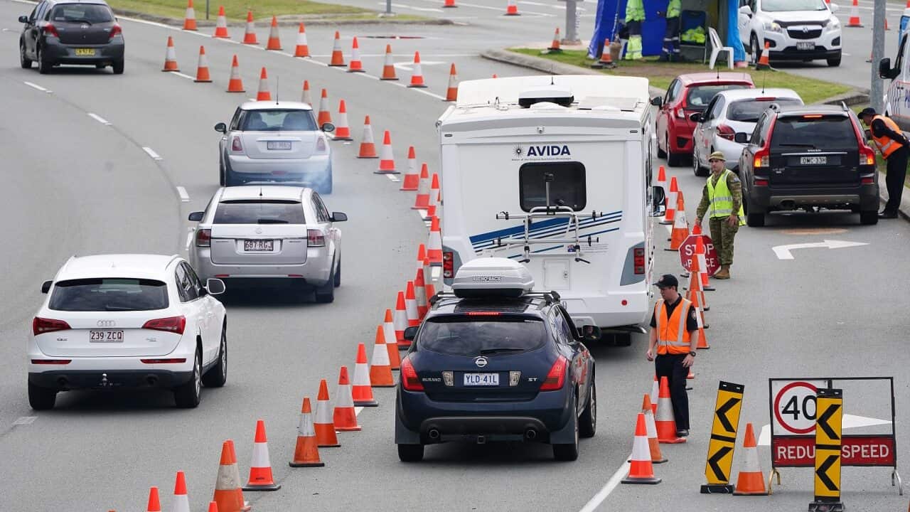 Motorists are stopped at a checkpoint at Coolangatta on the Queensland-New South Wales border.