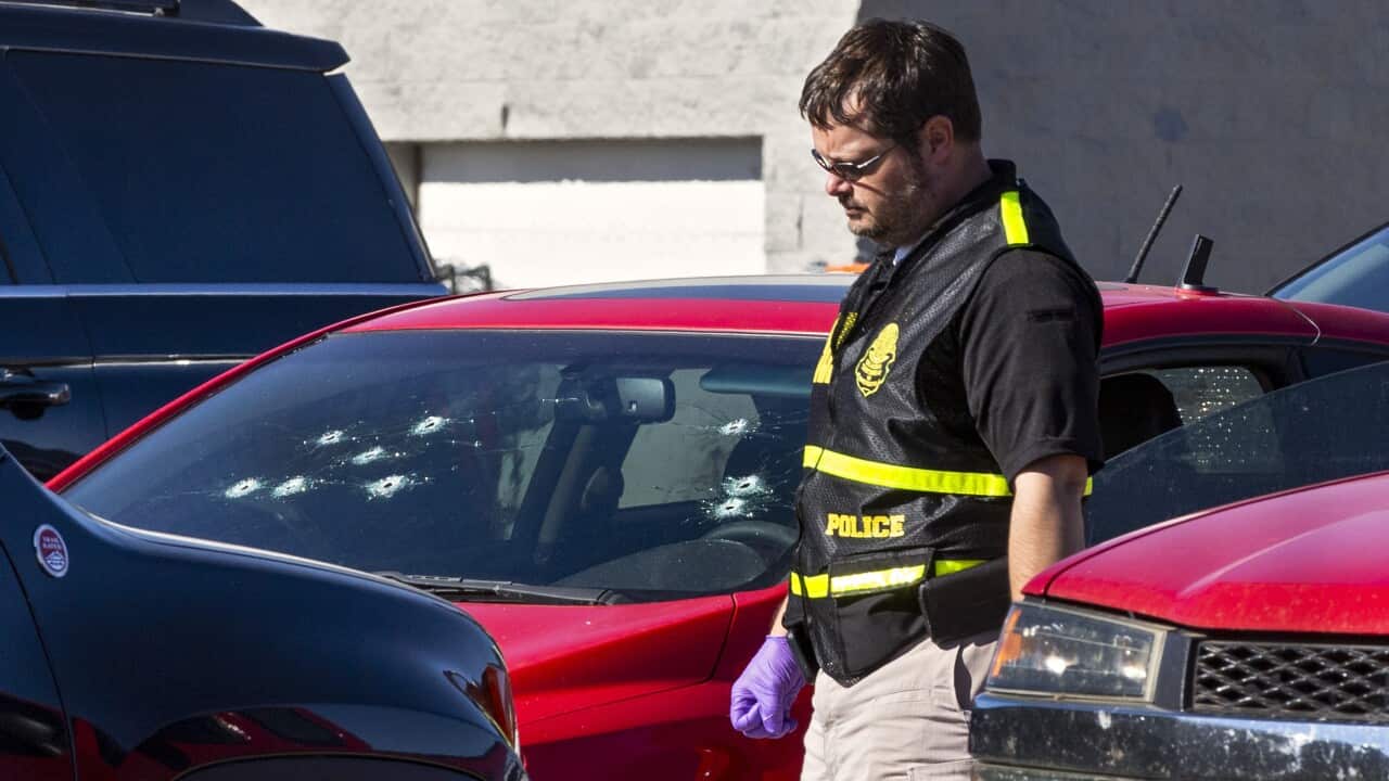 A member of the Oklahoma State Bureau of Investigation works the scene of a fatal shooting in the parking lot of a Walmart in Duncan, Okla., on Monday, Nov. 18, 2019. (Chris Landsberger/The Oklahoman via AP)