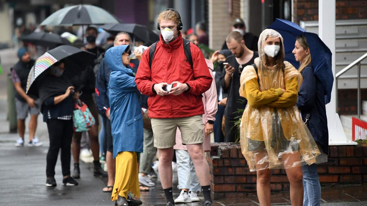 People are seen queuing outside a Centrelink office in Bondi Junction, Sydney.
