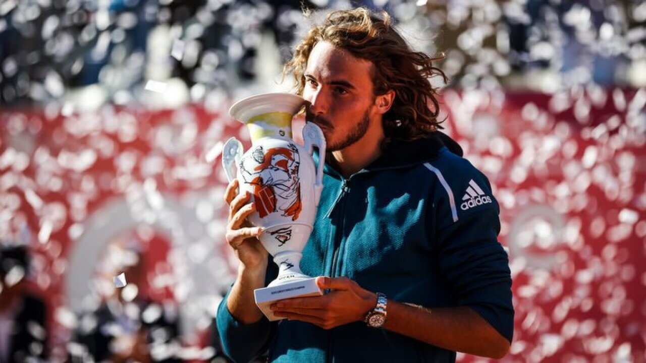Stefanos Tsitsipas celebrates with his trophy after winning the final match against Pablo Cuevas of Uruguay at the Estoril Open tennis tournament in Cascais, near Lisbon, Portugal