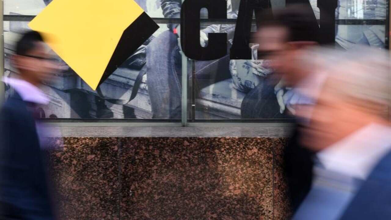 CBD workers walk past the a Commonwealth Bank