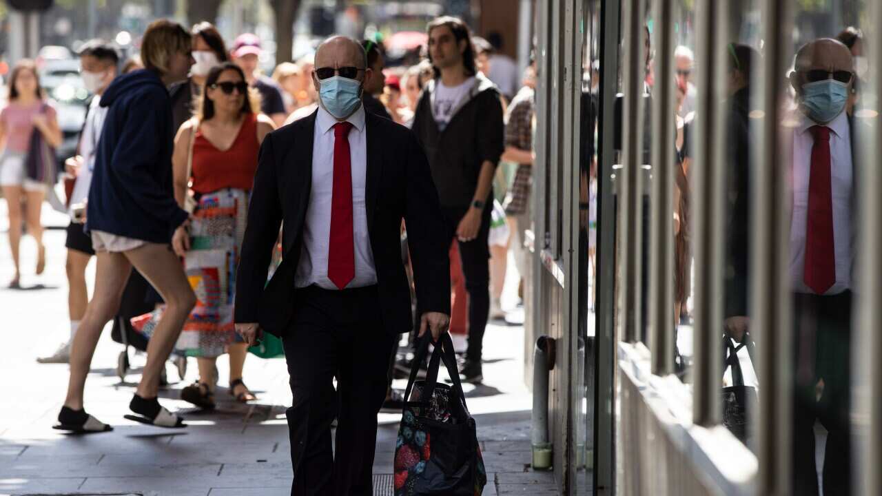 An image of a man walking down Elizabeth Street in Melbourne