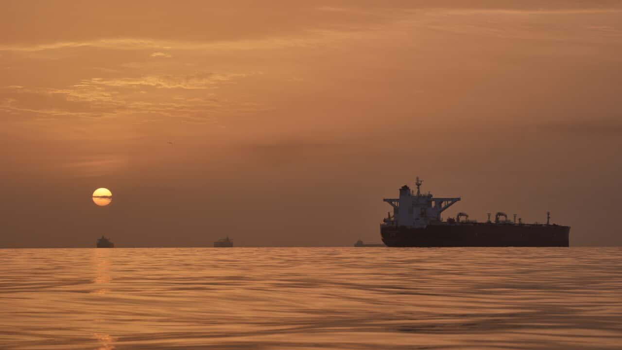 The sun rises behind tankers anchored in the Strait of Hormuz off the coast of Qeshm Island, Iran, Saturday, April 18, 2026