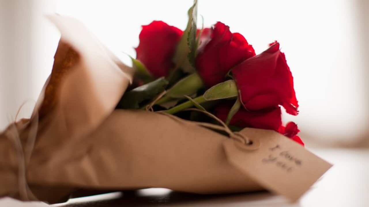 Close up of red roses with gift tag